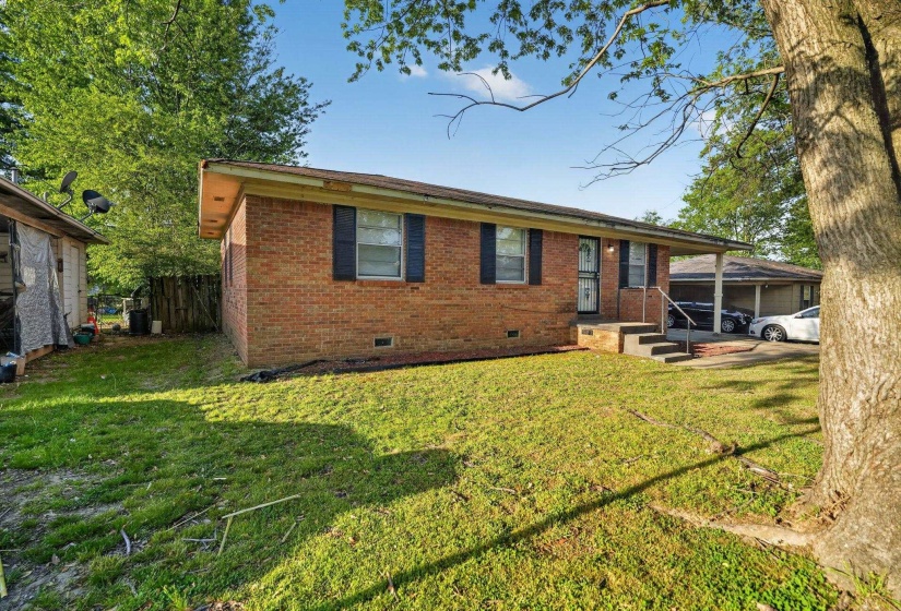 Single story home with crawl space, brick siding, and an attached carport