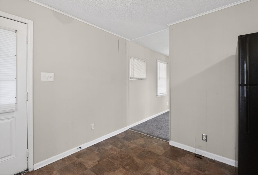 Spare room featuring stone finish floors, a textured ceiling, and ornamental molding