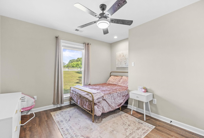 Bedroom with ceiling fan, dark wood-style floors, and recessed lighting