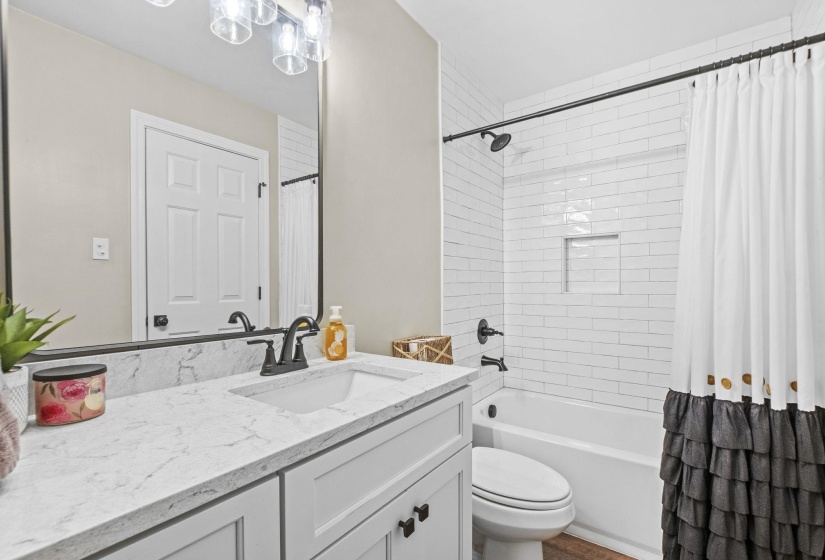 Full bath featuring vanity and shower / bathtub combination with curtain