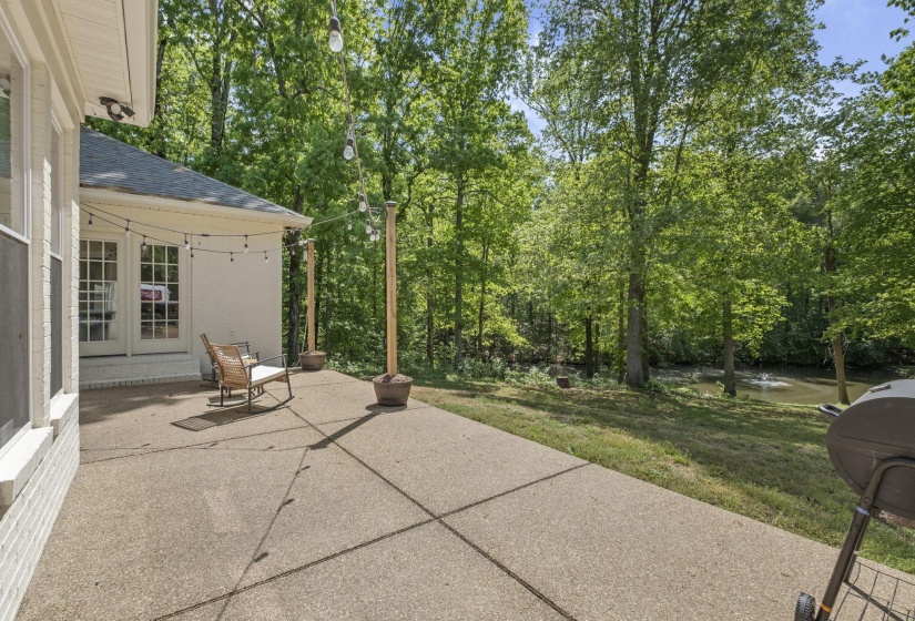 View of patio featuring view of wooded area