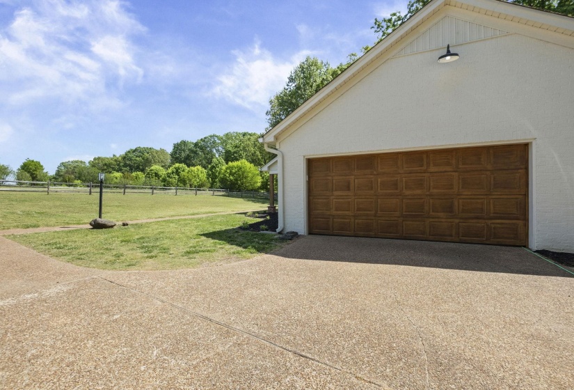 Garage featuring concrete driveway