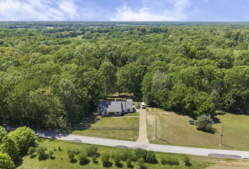View of subject property featuring a heavily wooded area