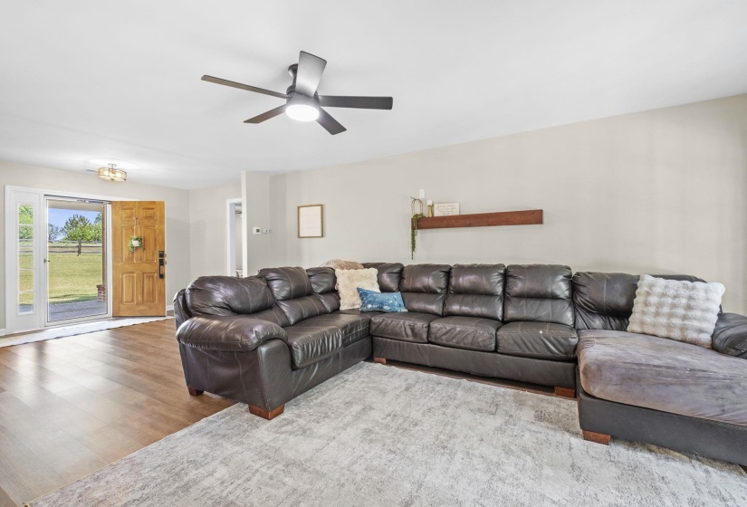 Living room featuring wood finished floors and a ceiling fan
