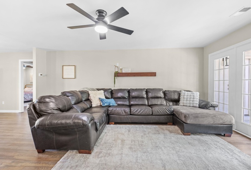 Living room featuring wood finished floors and a ceiling fan