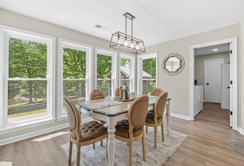 Dining area with light wood-style floors, a chandelier, and washer and clothes dryer