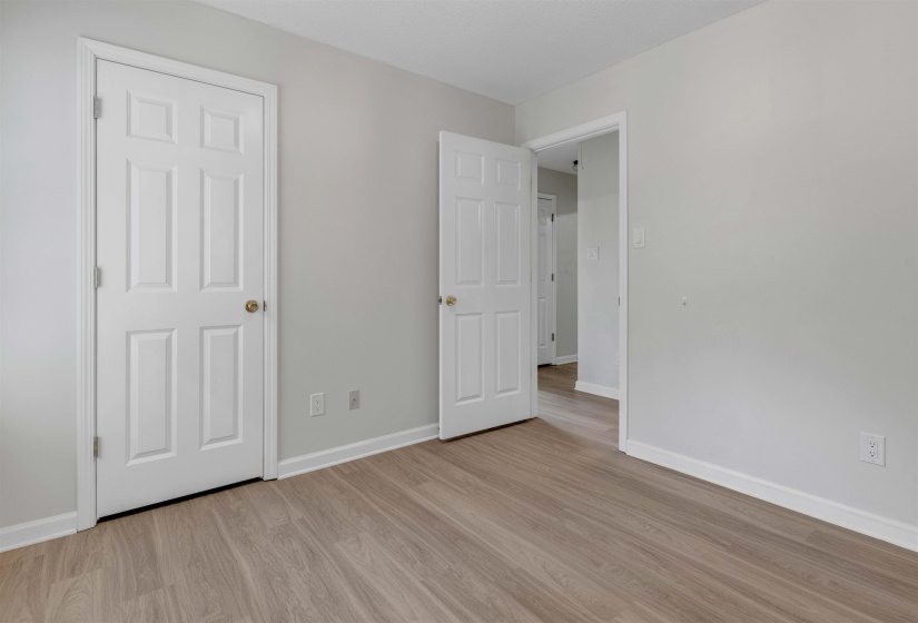 Unfurnished bedroom with baseboards and light wood-style flooring