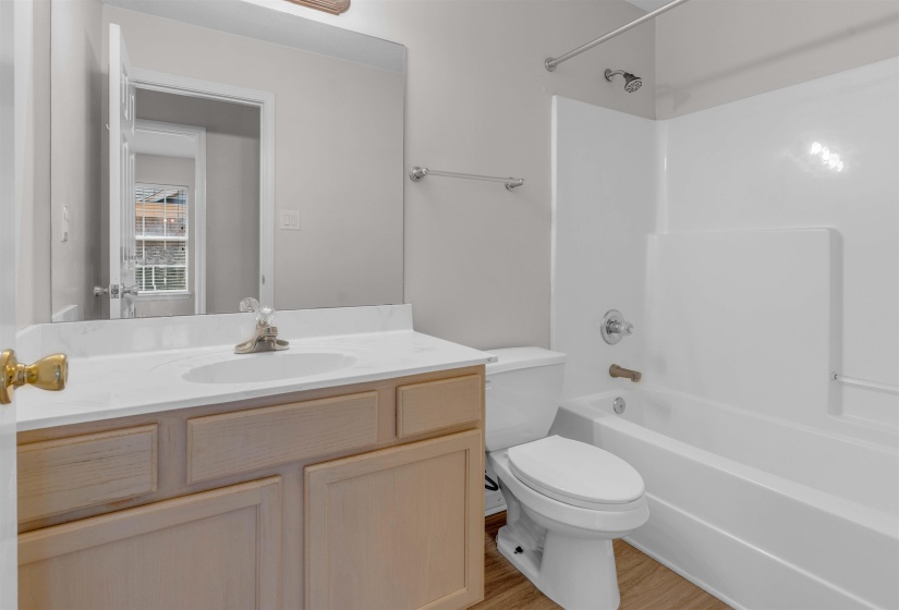 Full bathroom featuring vanity, shower / tub combination, and light wood finished floors