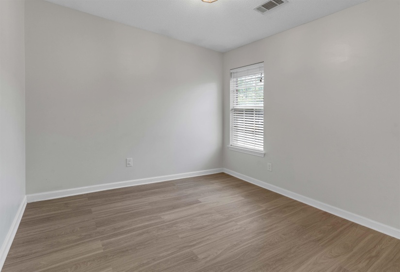 Unfurnished room with light wood-style flooring and baseboards