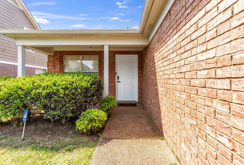 Entrance to property featuring brick siding