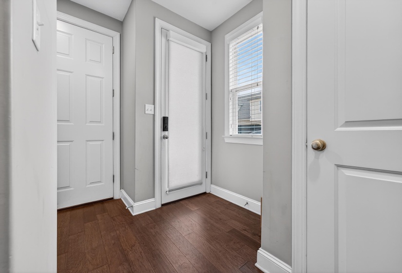 Entryway featuring baseboards and hardwood / wood-style floors