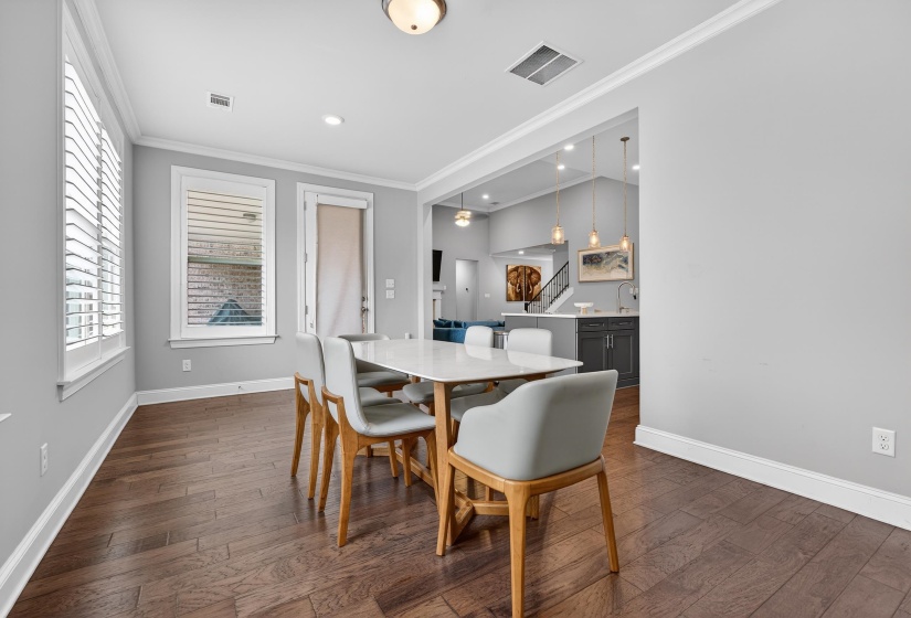 Dining room featuring ornamental molding, dark wood-type flooring, and recessed lighting