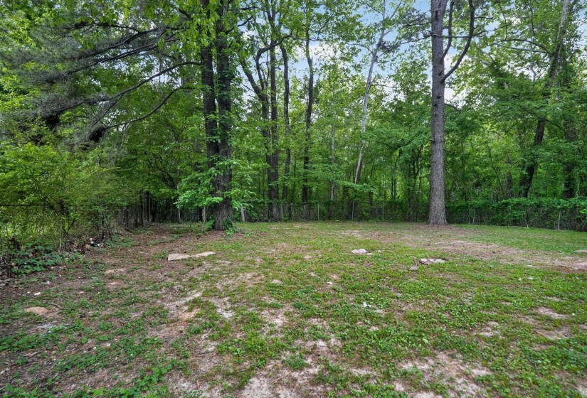 View of yard featuring a wooded view