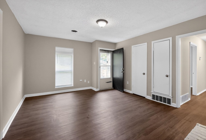 Entryway with dark wood finished floors and a textured ceiling