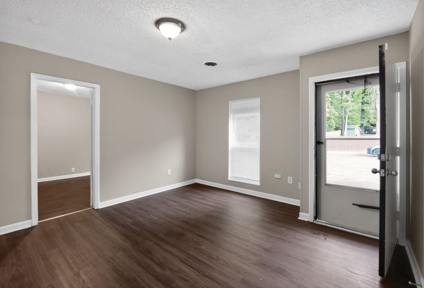 Entrance foyer with dark wood finished floors and a textured ceiling