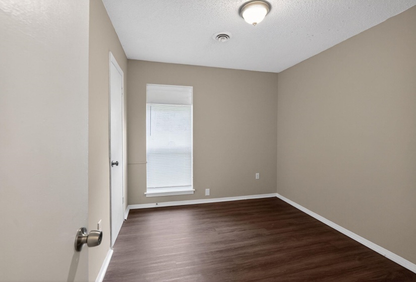 Spare room with dark wood finished floors and a textured ceiling