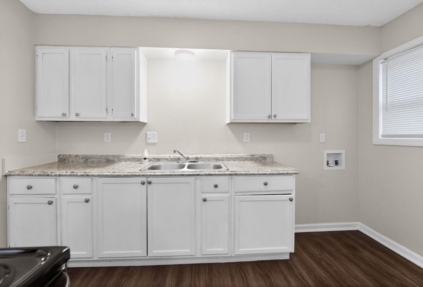 Laundry area with hookup for a washing machine and dark wood-type flooring