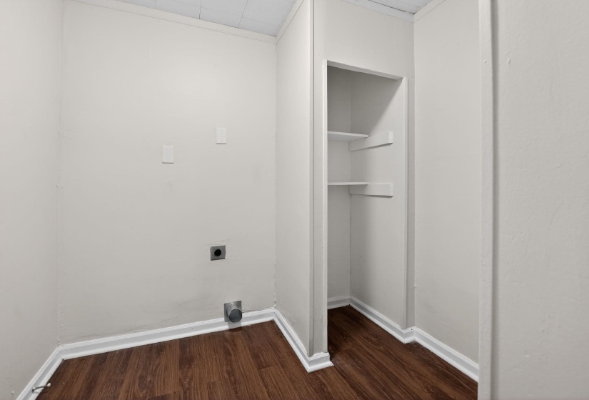 Laundry room with dark wood-type flooring and electric dryer hookup
