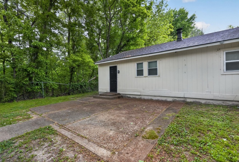 View of home's exterior featuring a shingled roof, entry steps, and a yard