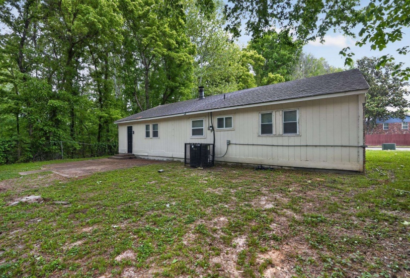 Rear view of property featuring a shingled roof