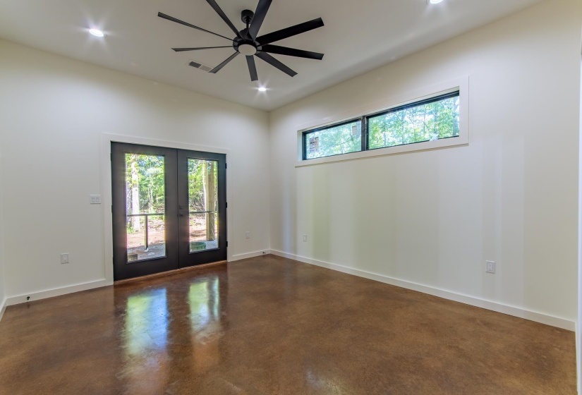 Empty room with concrete flooring, french doors, ceiling fan, and recessed lighting