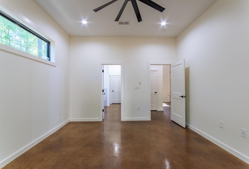 Unfurnished bedroom featuring concrete floors, a ceiling fan, and recessed lighting
