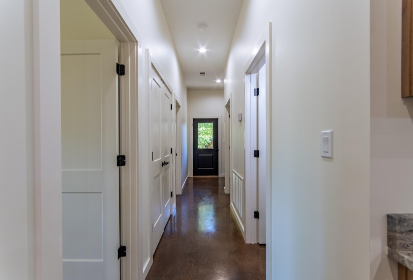 Hallway featuring finished concrete floors and recessed lighting