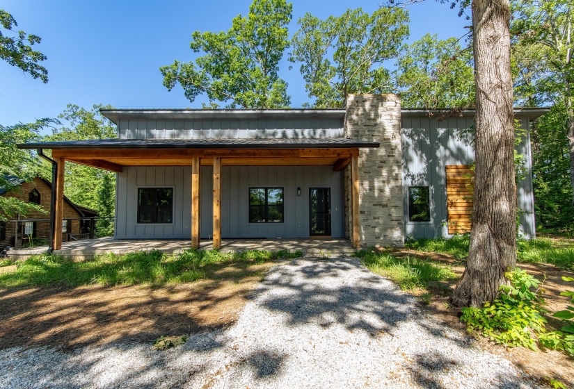 Contemporary house featuring a patio and board and batten siding