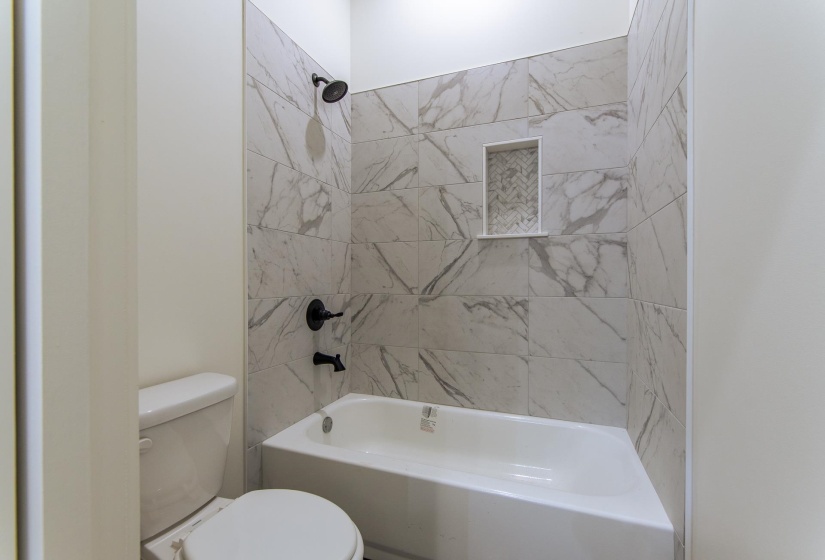Bathroom featuring toilet and shower / bathtub combination