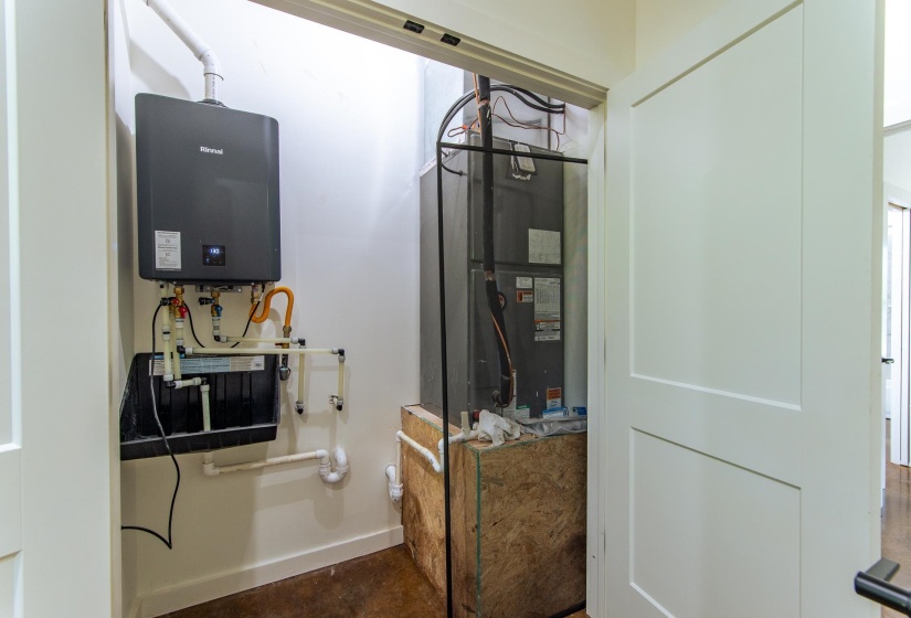 Utility room with heating unit and tankless water heater