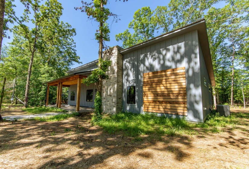 Rear view of property with board and batten siding and a chimney