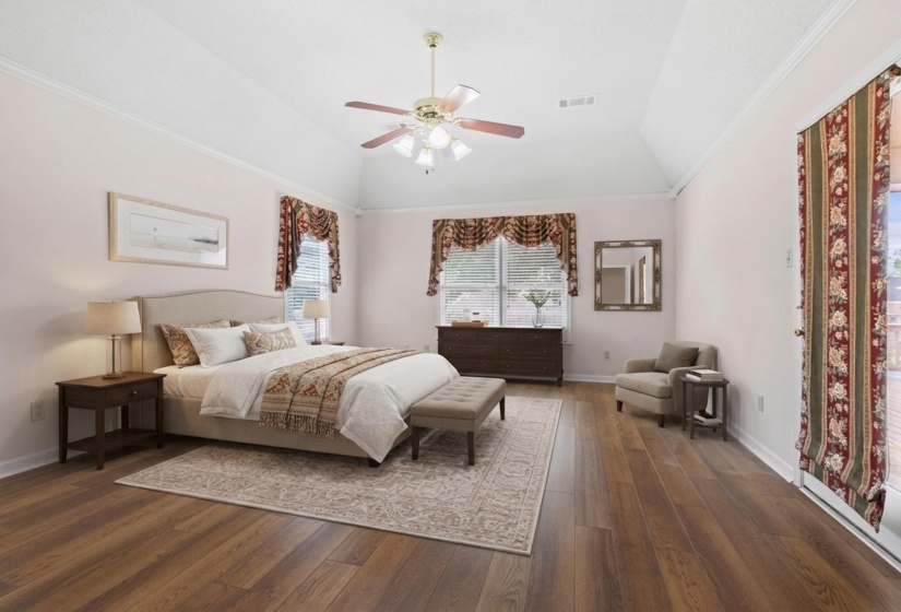 Bedroom with dark wood-style flooring, ornamental molding, a ceiling fan, and vaulted ceiling