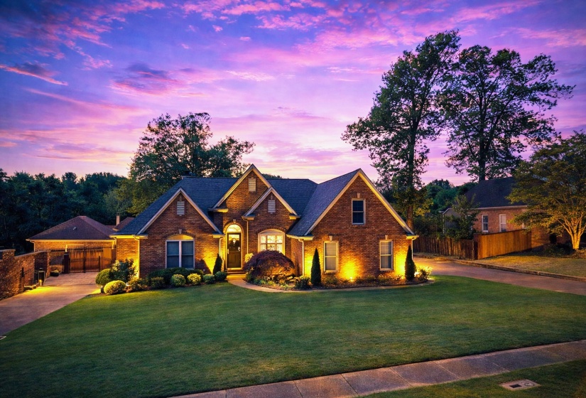 Traditional-style house with brick siding and concrete driveway