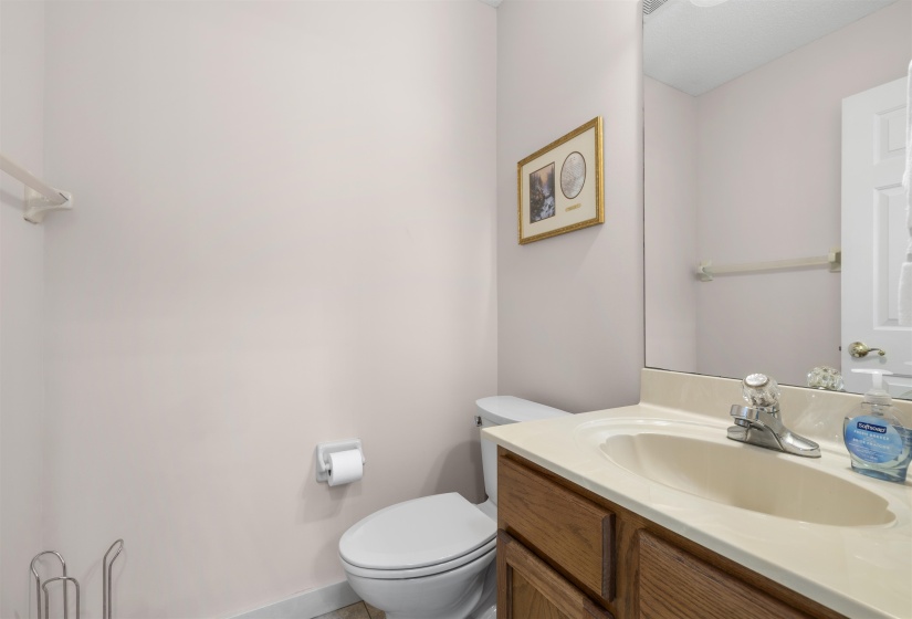 Half bath featuring vanity and toilet