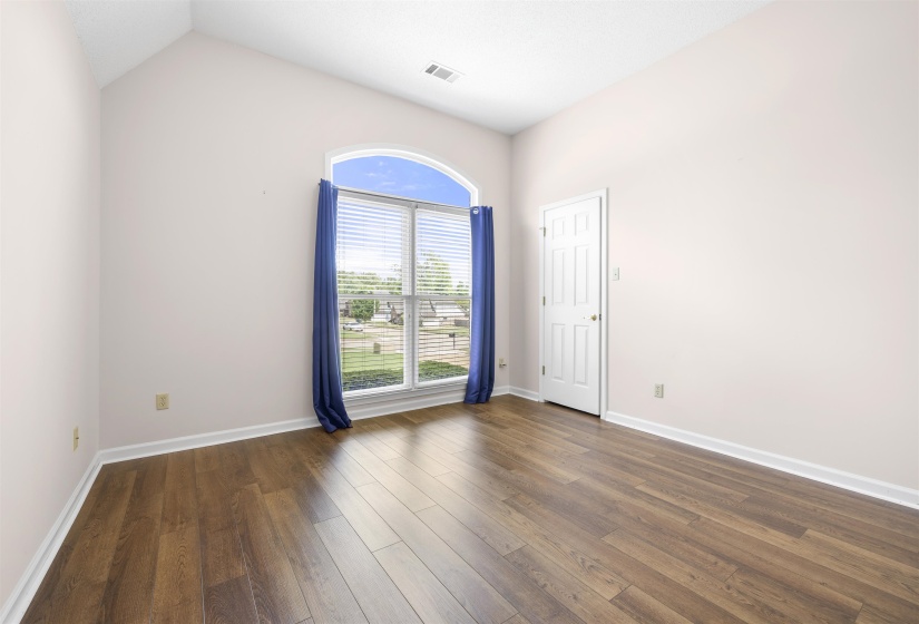 room featuring dark wood finished floors and vaulted ceiling