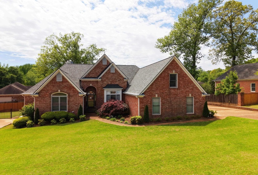View of front of home with brick siding and roof with shingles