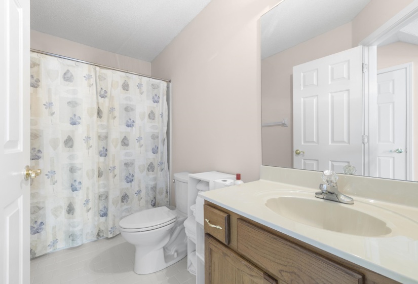Bathroom featuring vanity, a shower with shower curtain, and light tile patterned floors