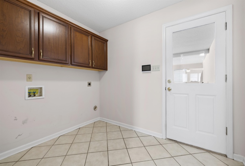 Laundry room featuring washer hookup, electric dryer hookup, cabinet space, and a textured ceiling