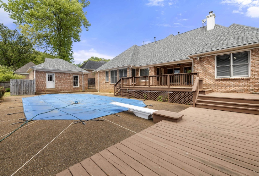 View of pool with a deck, a diving board, and patio surround