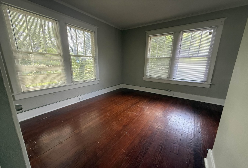Unfurnished room featuring dark wood finished floors and crown molding