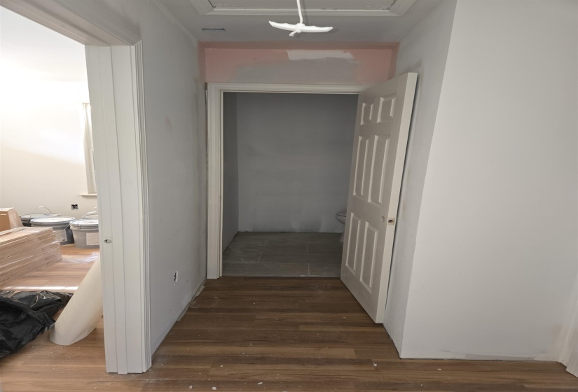 Corridor with dark wood-style flooring and attic access