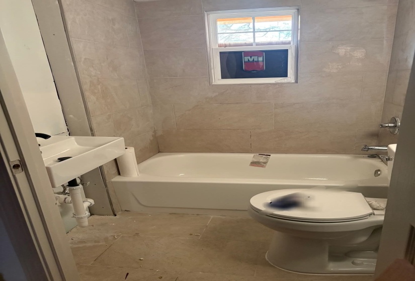 Bathroom featuring toilet and shower / bathtub combination