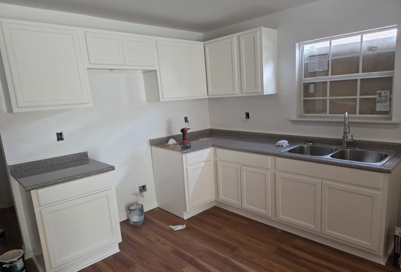 Kitchen featuring white cabinets and dark wood-style floors