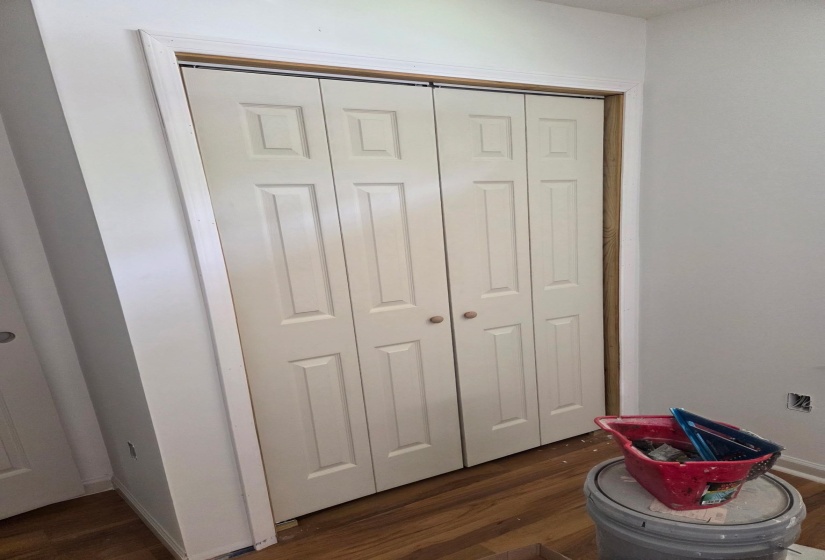 Unfurnished bedroom with dark wood finished floors and a closet