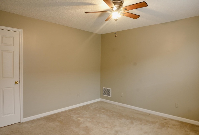 Spare room with ceiling fan and light colored carpet