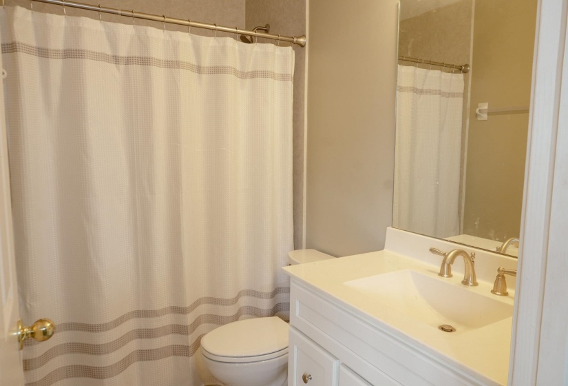 Full bath featuring vanity and curtained shower