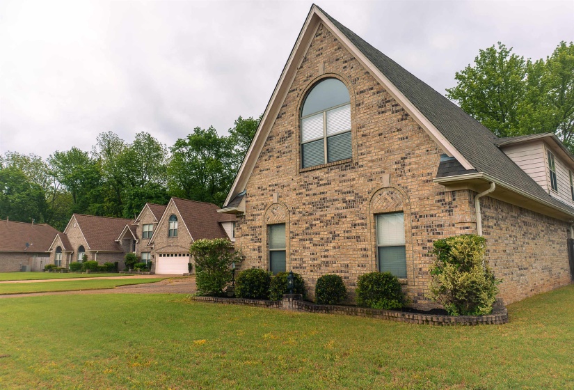 View of front of home featuring a front lawn and brick siding