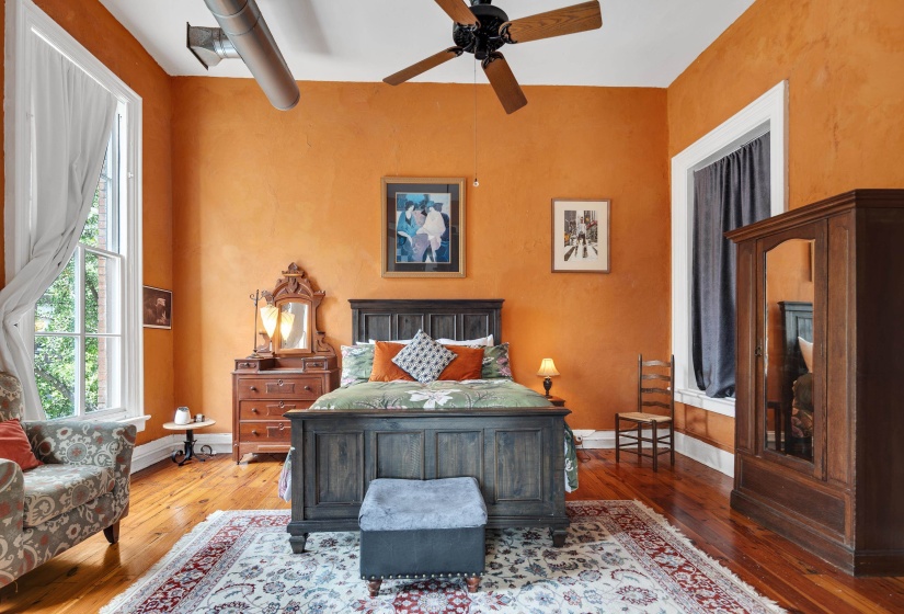 Bedroom with hardwood / wood-style floors and a ceiling fan