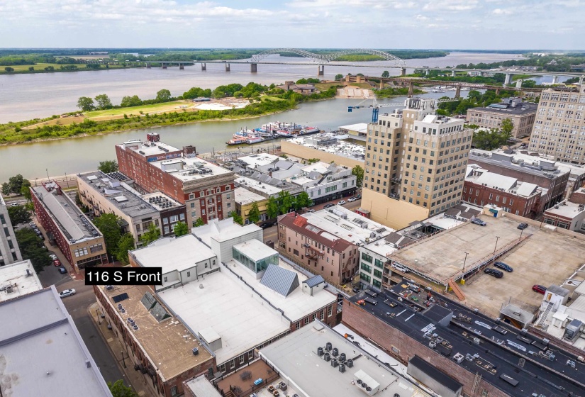 View of urban area featuring a nearby body of water and a notable bridge