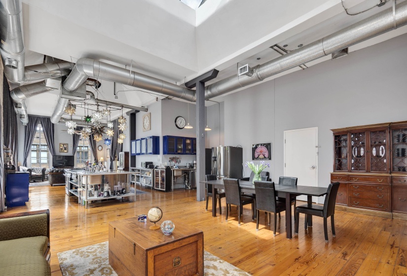 Dining space featuring a high ceiling and light wood-style floors